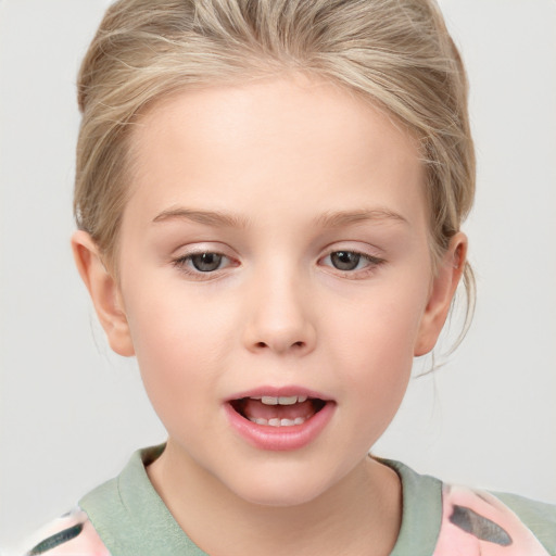 Joyful white child female with short  blond hair and grey eyes