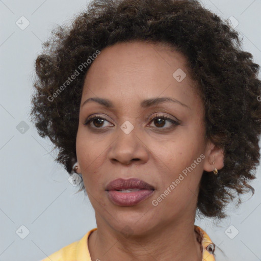 Joyful black adult female with medium  brown hair and brown eyes