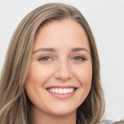 Joyful white young-adult female with long  brown hair and green eyes