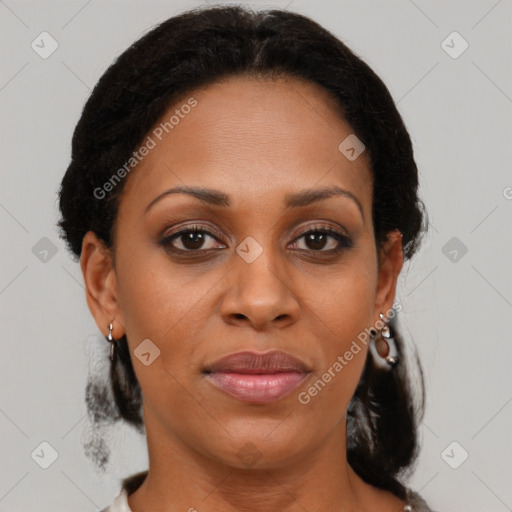 Joyful black adult female with medium  brown hair and brown eyes
