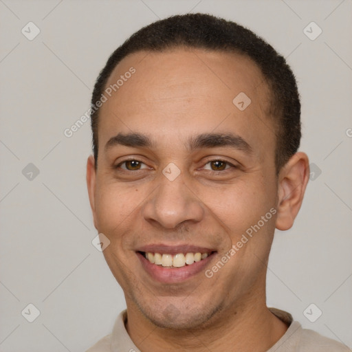 Joyful latino young-adult male with short  black hair and brown eyes