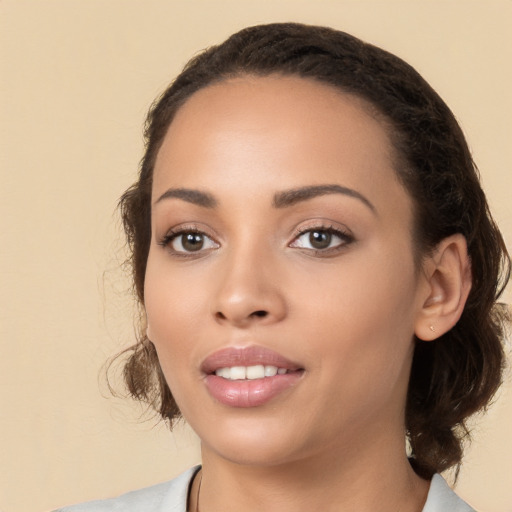 Joyful white young-adult female with medium  black hair and brown eyes