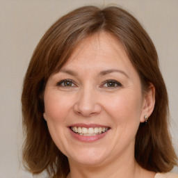 Joyful white adult female with medium  brown hair and brown eyes