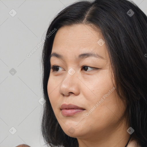 Joyful asian young-adult female with medium  black hair and brown eyes