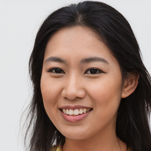 Joyful asian young-adult female with long  brown hair and brown eyes