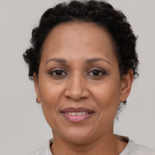 Joyful latino adult female with short  brown hair and brown eyes