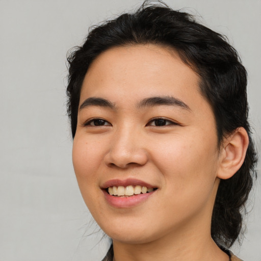 Joyful asian young-adult female with medium  black hair and brown eyes