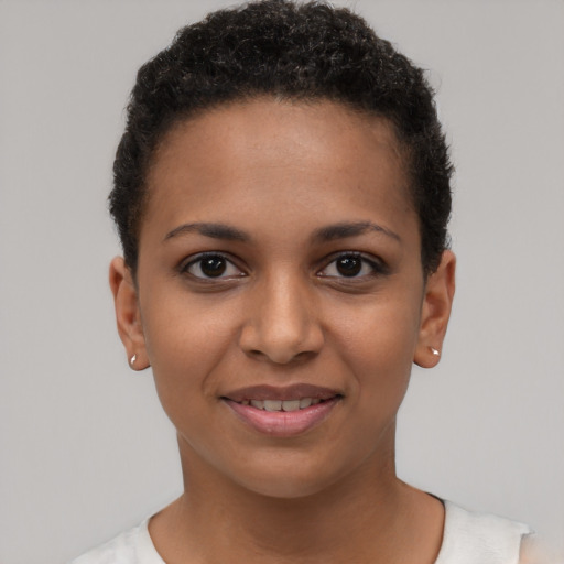Joyful latino young-adult female with short  black hair and brown eyes