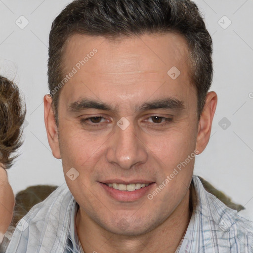 Joyful white adult male with short  brown hair and brown eyes