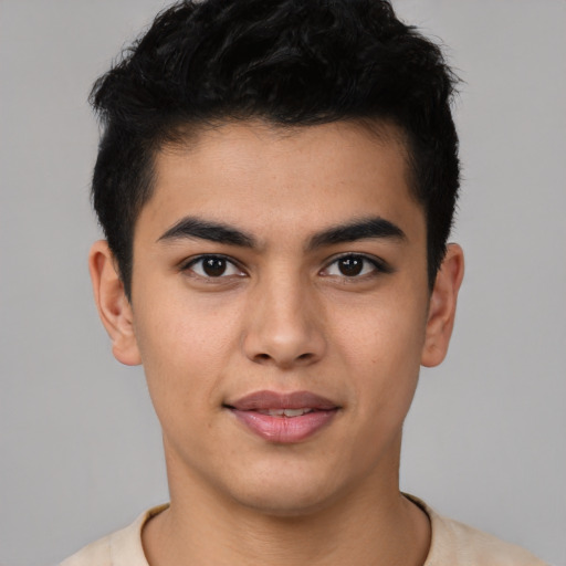 Joyful latino young-adult male with short  brown hair and brown eyes