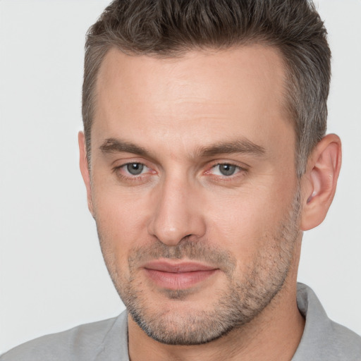 Joyful white adult male with short  brown hair and brown eyes