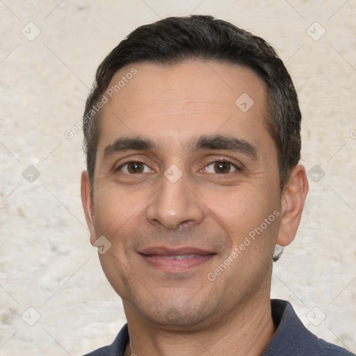 Joyful white young-adult male with short  black hair and brown eyes