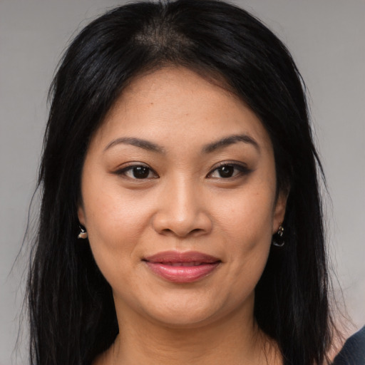 Joyful asian young-adult female with long  brown hair and brown eyes