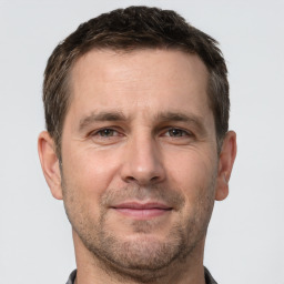 Joyful white adult male with short  brown hair and brown eyes