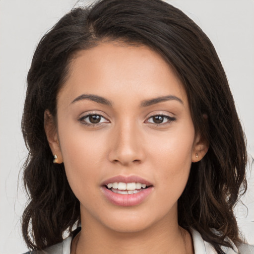 Joyful white young-adult female with long  brown hair and brown eyes