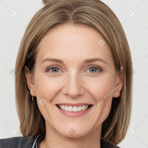 Joyful white adult female with medium  brown hair and grey eyes