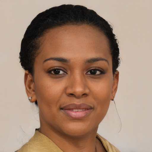 Joyful black young-adult female with short  brown hair and brown eyes