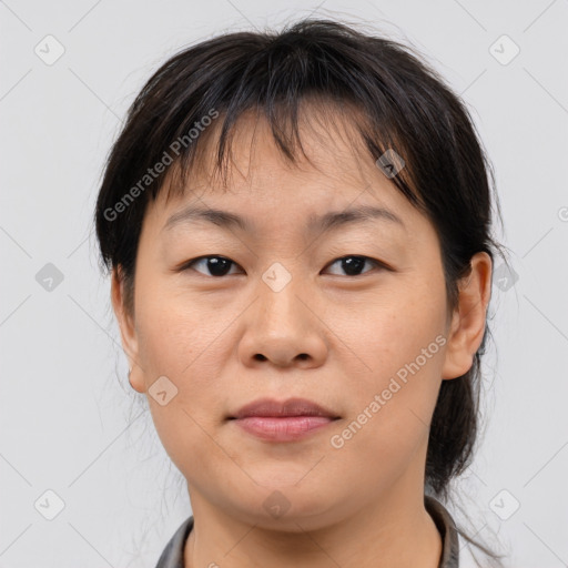 Joyful asian adult female with medium  brown hair and brown eyes