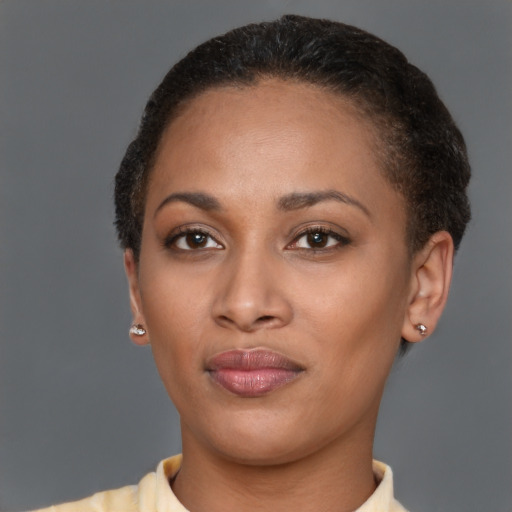 Joyful black young-adult female with short  brown hair and brown eyes