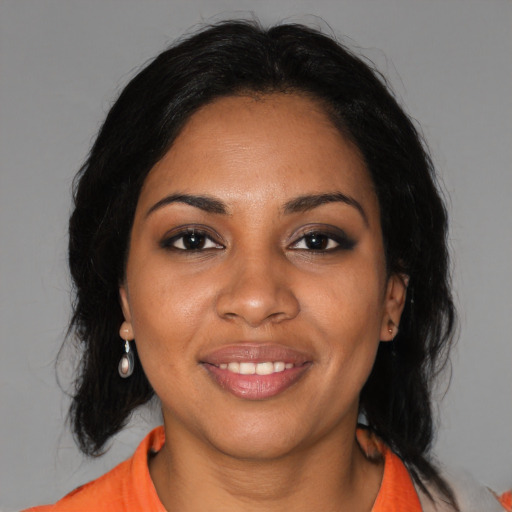 Joyful black young-adult female with medium  black hair and brown eyes