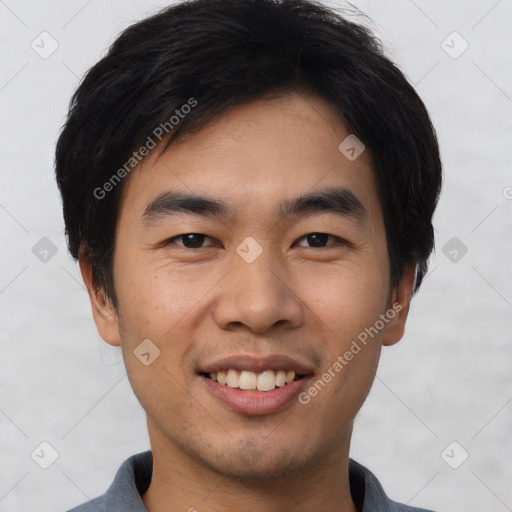 Joyful asian young-adult male with short  black hair and brown eyes