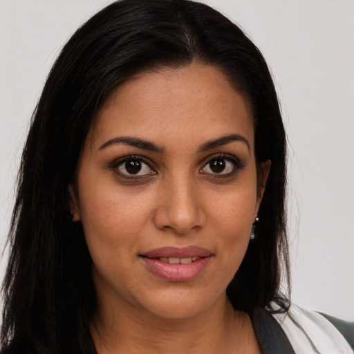 Joyful latino young-adult female with long  brown hair and brown eyes
