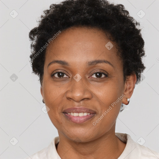 Joyful black adult female with short  brown hair and brown eyes