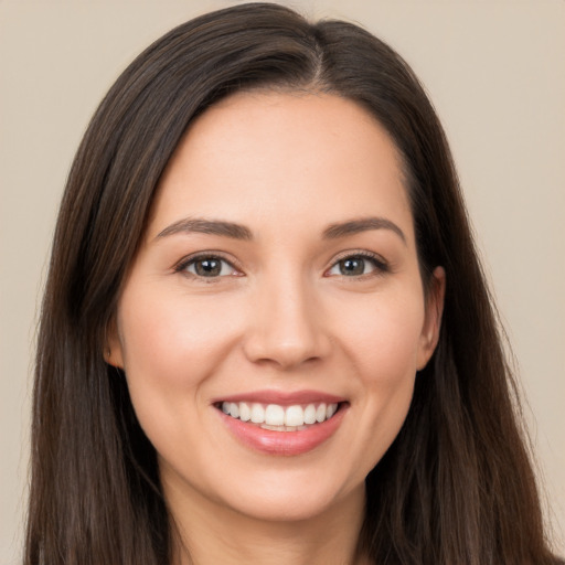 Joyful white young-adult female with long  brown hair and brown eyes