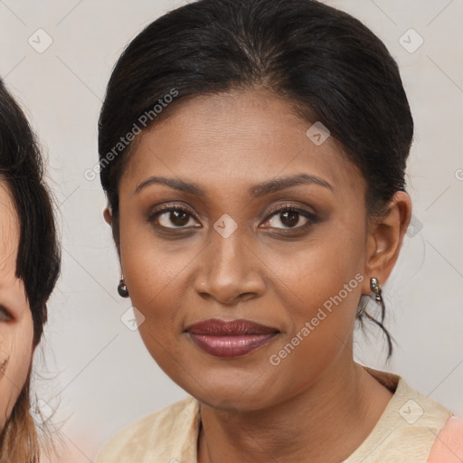 Joyful black young-adult female with medium  brown hair and brown eyes