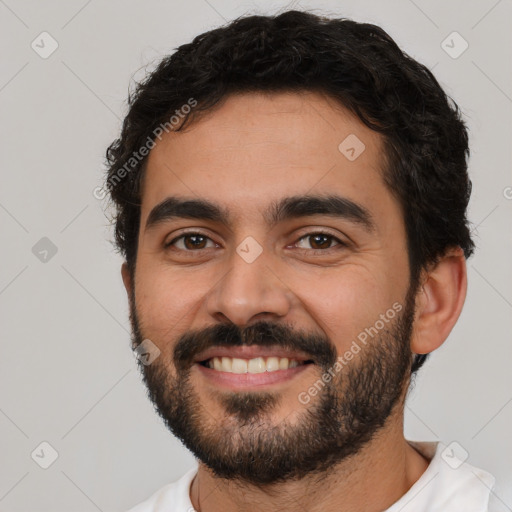 Joyful latino young-adult male with short  black hair and brown eyes