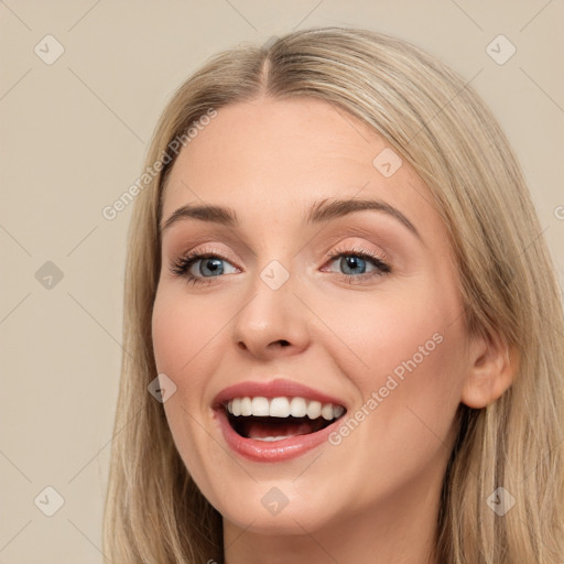 Joyful white young-adult female with long  brown hair and blue eyes