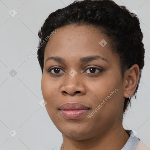 Joyful black young-adult female with short  black hair and brown eyes