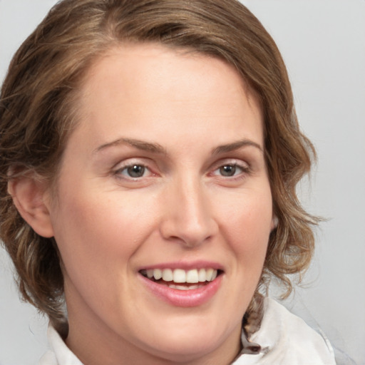 Joyful white young-adult female with medium  brown hair and blue eyes