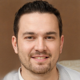 Joyful white adult male with short  brown hair and brown eyes