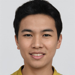 Joyful asian young-adult male with short  black hair and brown eyes