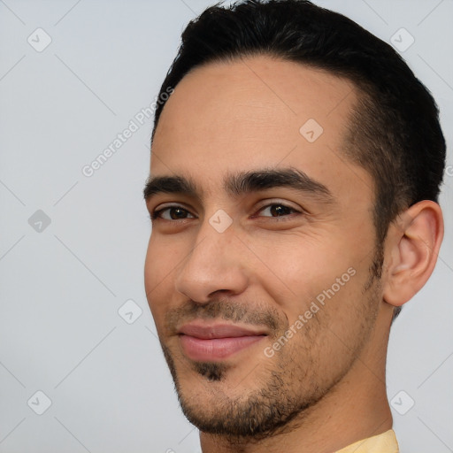 Joyful latino young-adult male with short  black hair and brown eyes