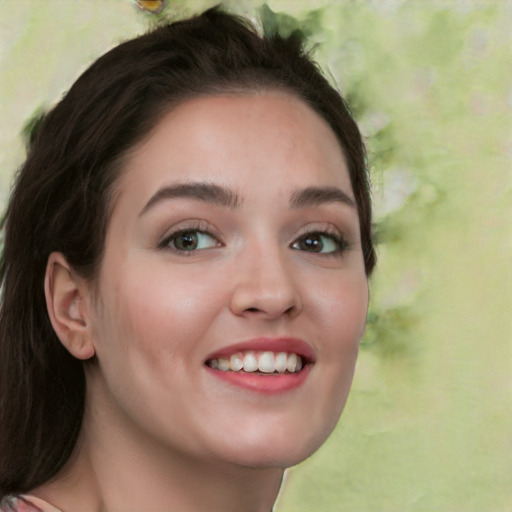 Joyful white young-adult female with long  brown hair and green eyes