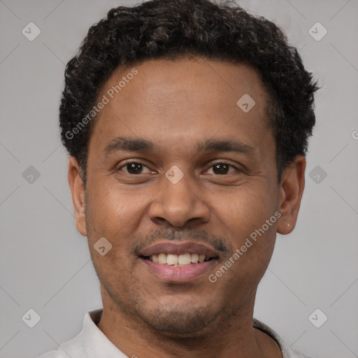 Joyful latino young-adult male with short  brown hair and brown eyes