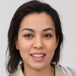 Joyful latino young-adult female with medium  brown hair and brown eyes