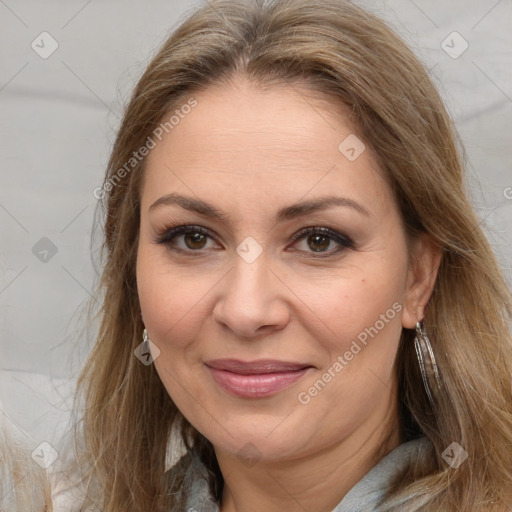 Joyful white adult female with long  brown hair and brown eyes