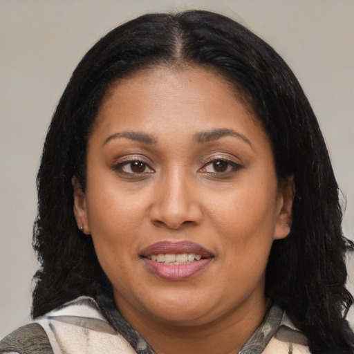 Joyful latino adult female with medium  black hair and brown eyes
