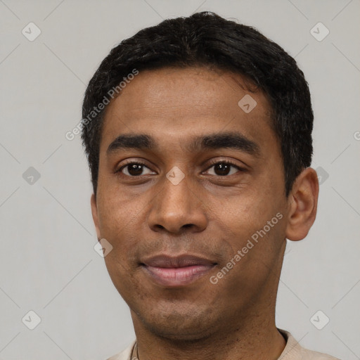 Joyful latino young-adult male with short  black hair and brown eyes