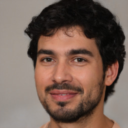 Joyful white young-adult male with short  black hair and brown eyes