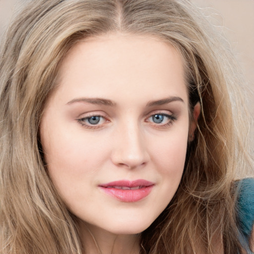 Joyful white young-adult female with long  brown hair and blue eyes