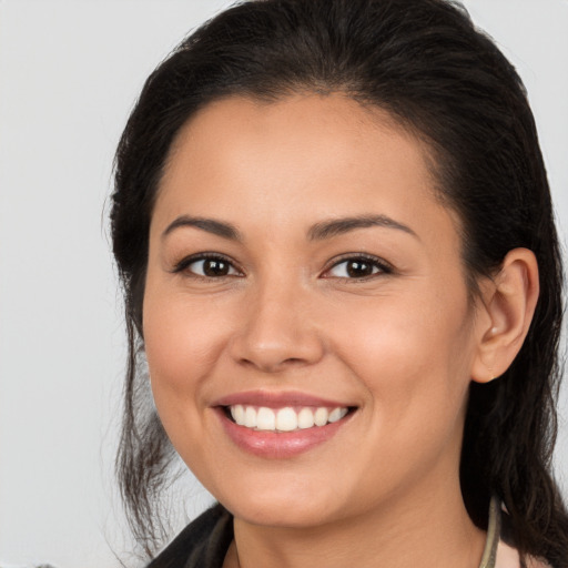 Joyful white young-adult female with long  brown hair and brown eyes