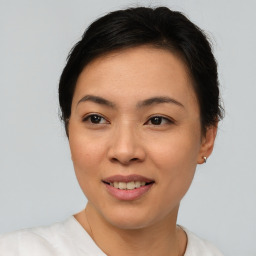 Joyful asian young-adult female with short  brown hair and brown eyes