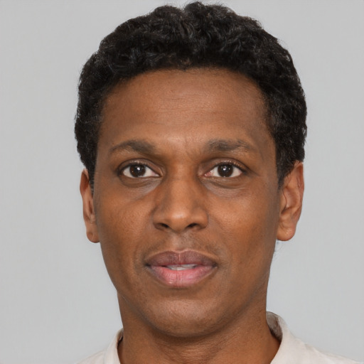Neutral black young-adult male with short  black hair and brown eyes