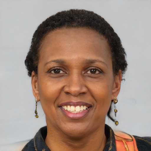 Joyful latino adult female with short  brown hair and brown eyes