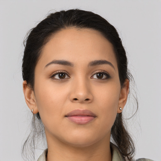 Joyful latino young-adult female with medium  brown hair and brown eyes