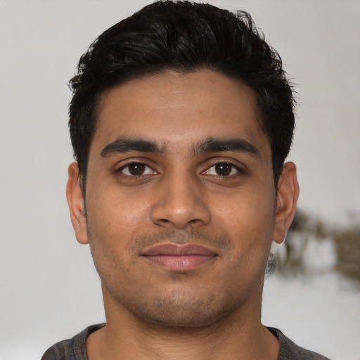 Joyful latino young-adult male with short  black hair and brown eyes